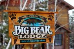 Big Bear Lodge front of cabin with sign.